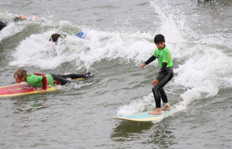 Children surfing and body boarding